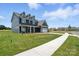 Charming two-story home with a well-manicured lawn on a sunny day in a walkable neighborhood at 3214 Mcharney Dr # 34, Harrisburg, NC 28075