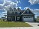Beautiful two-story home featuring a two car garage, dormer windows, and professionally landscaped yard at 3214 Mcharney Dr # 34, Harrisburg, NC 28075
