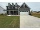 Charming two-story home with a well-manicured lawn and a classic dark gray exterior at 3214 Mcharney Dr # 34, Harrisburg, NC 28075