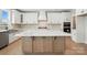 Modern kitchen featuring a large center island with white countertop and custom cabinets and backsplash at 3214 Mcharney Dr # 34, Harrisburg, NC 28075