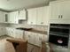 Modern kitchen features white cabinets, stainless steel appliances, and a stylish backsplash at 3214 Mcharney Dr # 34, Harrisburg, NC 28075