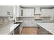 The kitchen features stainless steel appliances, a farm sink and custom backsplash with white countertops at 3214 Mcharney Dr # 34, Harrisburg, NC 28075
