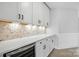 Kitchenette with wine cooler, custom backsplash, white countertops, and cabinetry at 3214 Mcharney Dr # 34, Harrisburg, NC 28075