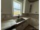 The kitchen showcases elegant white cabinetry, a farmhouse sink, quartz countertops, and stylish backsplash at 3214 Mcharney Dr # 34, Harrisburg, NC 28075