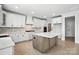 Spacious kitchen showcasing an island with a light countertop, custom backsplash and cabinets at 3214 Mcharney Dr # 34, Harrisburg, NC 28075