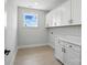 Functional laundry room with ample storage, white cabinets and countertop at 3214 Mcharney Dr # 34, Harrisburg, NC 28075