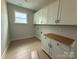 Functional laundry room offering ample storage with overhead cabinets and a dedicated folding area at 3214 Mcharney Dr # 34, Harrisburg, NC 28075