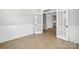 Open room with plank flooring, board and batten trim, and double doors at 3214 Mcharney Dr # 34, Harrisburg, NC 28075