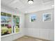 Cozy living room filled with natural light from multiple windows, paneled accent wall and plank flooring at 3214 Mcharney Dr # 34, Harrisburg, NC 28075