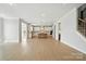 Open-concept living room with hardwood floors leading to the kitchen and staircase at 3214 Mcharney Dr # 34, Harrisburg, NC 28075