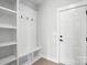 Functional mudroom with built-in bench, storage cubbies, coat hooks and entry door at 3214 Mcharney Dr # 34, Harrisburg, NC 28075