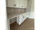 Bright office nook with white cabinets, quartz countertops, and stylish backsplash at 3214 Mcharney Dr # 34, Harrisburg, NC 28075