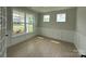 Cozy office space with wainscoting and multiple windows that look out onto the front yard at 3214 Mcharney Dr # 34, Harrisburg, NC 28075