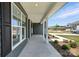 Covered porch features classic columns, neutral gray siding, and manicured landscaping at 3214 Mcharney Dr # 34, Harrisburg, NC 28075