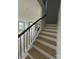 Elegant staircase with wood treads, white risers, and black metal railings at 3214 Mcharney Dr # 34, Harrisburg, NC 28075