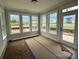Sun-drenched sun room offering expansive views of the outdoors through large windows and a glass door at 3214 Mcharney Dr # 34, Harrisburg, NC 28075