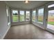 Sunroom with floor to ceiling windows offering views of pond and backyard at 3214 Mcharney Dr # 34, Harrisburg, NC 28075
