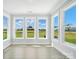 Sunroom filled with natural light from the multiple windows, overlooking the green lawn at 3214 Mcharney Dr # 34, Harrisburg, NC 28075