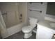 This bathroom features a shower-tub combo, toilet, glass shelving, tiled flooring, vanity with a sink, and a mirror at 331 Eastwood Dr, Salisbury, NC 28146