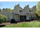 Rear view of a townhome with a screened porch and a balcony overlooking a green lawn at 331 Eastwood Dr, Salisbury, NC 28146