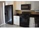 Well-appointed kitchen with black appliances and white cabinetry for ample storage at 331 Eastwood Dr, Salisbury, NC 28146