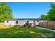 Spacious backyard featuring a deck, well-maintained lawn, and a fenced perimeter at 3678 Old Camden Hwy, Heath Springs, SC 29058