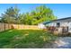Spacious fenced backyard with a well-maintained lawn and a wooden deck perfect for outdoor relaxation and entertaining at 3678 Old Camden Hwy, Heath Springs, SC 29058