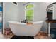 Bright bathroom featuring a freestanding tub, vanity area, and a window with natural light at 3678 Old Camden Hwy, Heath Springs, SC 29058