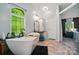 Bright bathroom featuring a freestanding tub, vanity area, and a window with natural light at 3678 Old Camden Hwy, Heath Springs, SC 29058