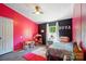 Bright bedroom featuring pink accent wall, modern ceiling fan, a play shop and an abundance of natural light at 3678 Old Camden Hwy, Heath Springs, SC 29058