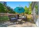 Cozy outdoor deck with wicker furniture, a grill, and an umbrella for shaded relaxation at 3678 Old Camden Hwy, Heath Springs, SC 29058