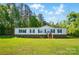 Charming one-story home featuring green shutters and a spacious yard, surrounded by lush trees and a bright blue sky at 3678 Old Camden Hwy, Heath Springs, SC 29058