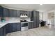 Well-equipped kitchen features modern appliances, granite countertops, tile backsplash and desk area at 3678 Old Camden Hwy, Heath Springs, SC 29058