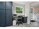 Functional laundry area with modern appliances, built-in desk, and abundant natural light at 3678 Old Camden Hwy, Heath Springs, SC 29058
