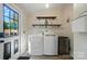 Neat laundry room featuring washer, dryer, storage shelves, and a convenient utility sink at 3678 Old Camden Hwy, Heath Springs, SC 29058