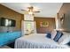 Main bedroom featuring brown walls, a ceiling fan and entry to the ensuite bath at 3678 Old Camden Hwy, Heath Springs, SC 29058
