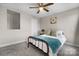 Bedroom includes a ceiling fan, carpet floors and a bed with decorative pillows at 3722 Windy Pine Nw Ln, Hickory, NC 28601