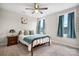 Cozy bedroom with a bed, ceiling fan, and two windows with curtains at 3722 Windy Pine Nw Ln, Hickory, NC 28601