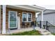 Inviting front porch with stone accents, seating, and a charming decorative sign at 3722 Windy Pine Nw Ln, Hickory, NC 28601