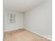 Bedroom with neutral walls, carpet, and window overlooking green space, offering a serene and comfortable environment at 3941 Briarhill Dr, Charlotte, NC 28215
