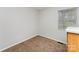 A simple bedroom features carpet and a window overlooking green space, offering a serene and comfortable environment at 3941 Briarhill Dr, Charlotte, NC 28215