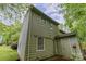 Two-story home with a traditional roof and backyard with room for gardening at 3941 Briarhill Dr, Charlotte, NC 28215