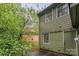 Back of the home with vinyl siding, windows, and a view of the green yard at 3941 Briarhill Dr, Charlotte, NC 28215