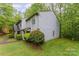 Side view of the home surrounded by trees at 3941 Briarhill Dr, Charlotte, NC 28215