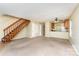 Open-concept living area with staircase, and view into the kitchen at 3941 Briarhill Dr, Charlotte, NC 28215