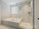Elegant bathroom with glass shower, soaking tub, and modern tile design at 423 Sensibility Cir, Fort Mill, SC 29708