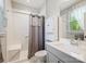 Clean bathroom featuring a tub with tile surround, vanity with sink, and natural light at 423 Sensibility Cir, Fort Mill, SC 29708