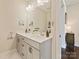 Modern bathroom with double sinks, large mirror, and neutral color palette at 423 Sensibility Cir, Fort Mill, SC 29708