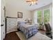 Comfortable bedroom with neutral decor, hardwood floors, and a bright window at 423 Sensibility Cir, Fort Mill, SC 29708