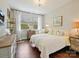 Cozy bedroom with a wooden dresser, chandelier, and sunny window view at 423 Sensibility Cir, Fort Mill, SC 29708